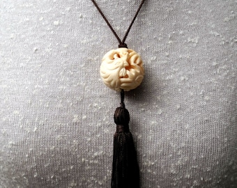 One of a Kind Tassel Necklace with Intricately Carved Ivory Bone Bead Depicting a Crested Bird with Long Tail Feathers, Brown Silk Tassel