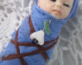 Swaddled podling child, elf baby, fairy baby, make believe Metamorphosis