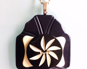 Black and white button and buckle pendant necklace