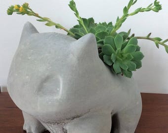 Giant concrete Bulbasaur planter