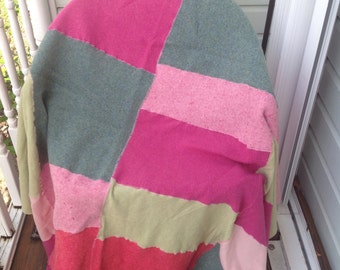 Handmade soft colorful pink and green wool patchwork throw blanket. Bedding. Sleep.