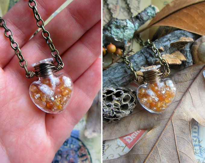 Vial necklace filled with amber color faceted Agate and Swarovski crystals. Custom length chain.