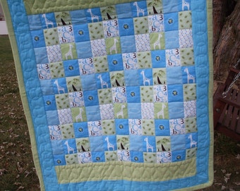 Hand quilted and hand made flannel quilt for baby boy.