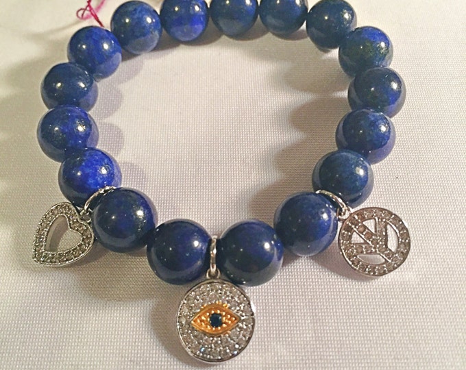 Spiritual beaded blue lapis trendy stretch bracelet adorned with an evil eye, peace sign and love heart charms