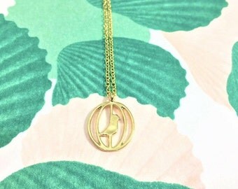 Gold bird in a cage pendant necklace