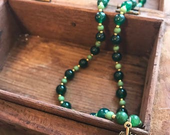 Green and gold feather pendant necklace