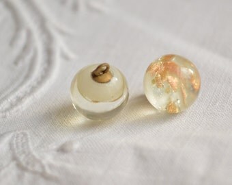 A vintage Czech glass paperweight button, white with mica gold flecks 1/2 inch