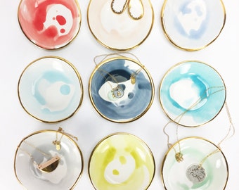 Handmade ceramic ring dish in white with a wash of watercolor glaze adorned with 22K gold edges