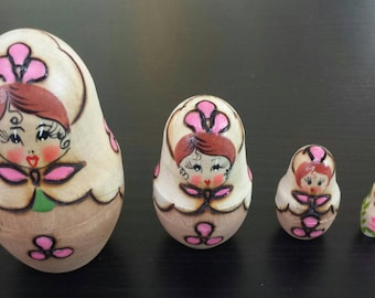 Set of four colorful Russian nesting dolls, lightweight wood, detailed painting. Matryoshka nesting dolls