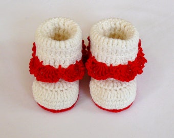 White crochet baby booties for a girl.