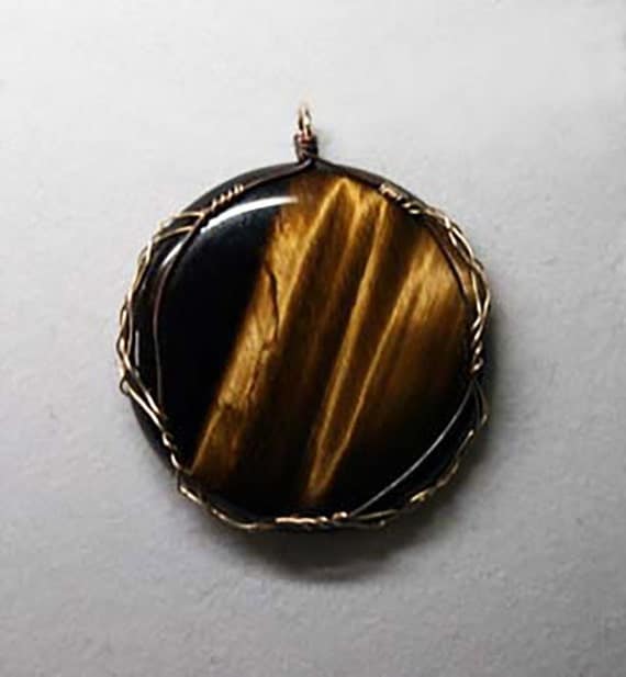 Tiger's eye cabochon wrapped in a Celtic style