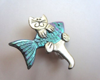 Cat holding an iridescent Fish Pin Brooch