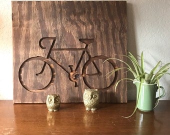 Bicycle engraved on 16"x16" plywood stained with dark walnut