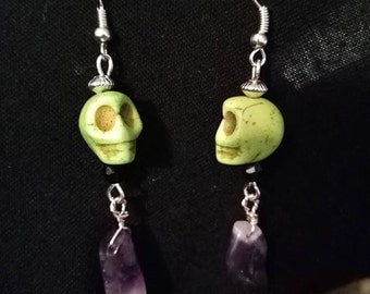 green skull earrings with a amethyst drop