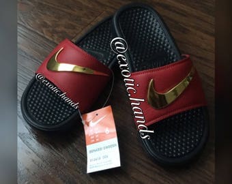 black nike slides with gold swoosh