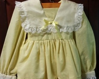 An adorable little girl yellow vintage 1960's dress.