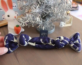 Patterned fabric and fleece dog bone shaped toy
