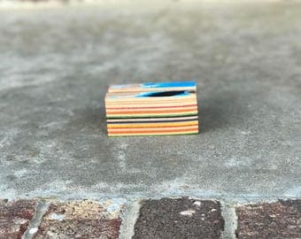 Recycle skateboard business card holder.