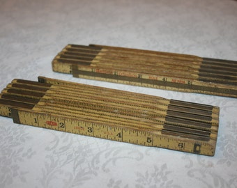 Two Vintage Industrial Wood and Metal Yellow Folding Extension Ruler Measuring Stick USA