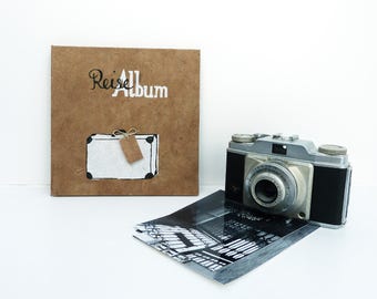 Accordion Book, brown scrapbooking album, suitcase, lettering design screen printed onto lokta paper