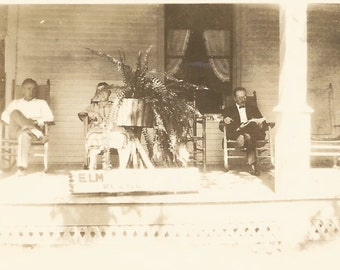 Vintage Snapshot "Elm St. Boarding House" Front Porch Rocking Chairs Boston Fern Plant Stand Reading Newspaper Found Photo