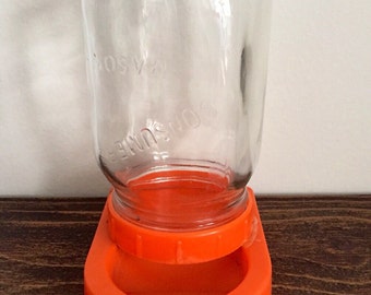 Vintage orange Mason jar bird feeder.