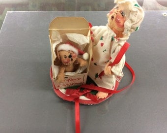 Annalee doll mother holding opened gift with bear coming out
