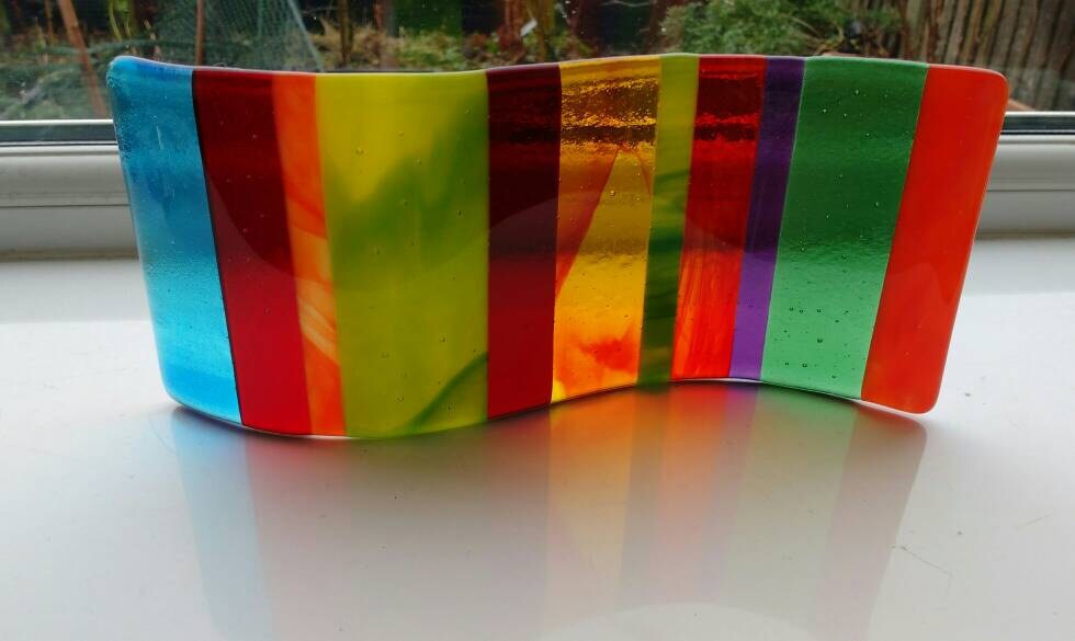 Multi-coloured double curve fused glass ornament