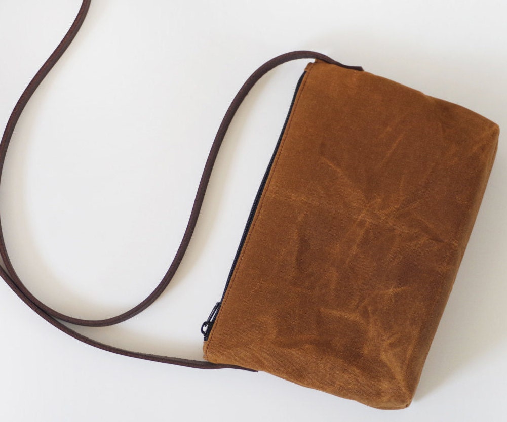 Small brown waxed canvas crossbody bag with leather straps