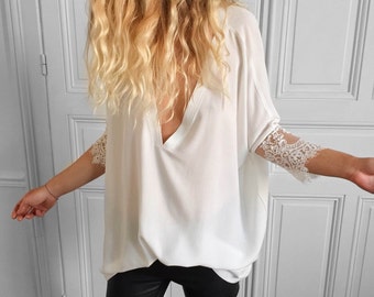 White sweater with v-neck and long sleeves