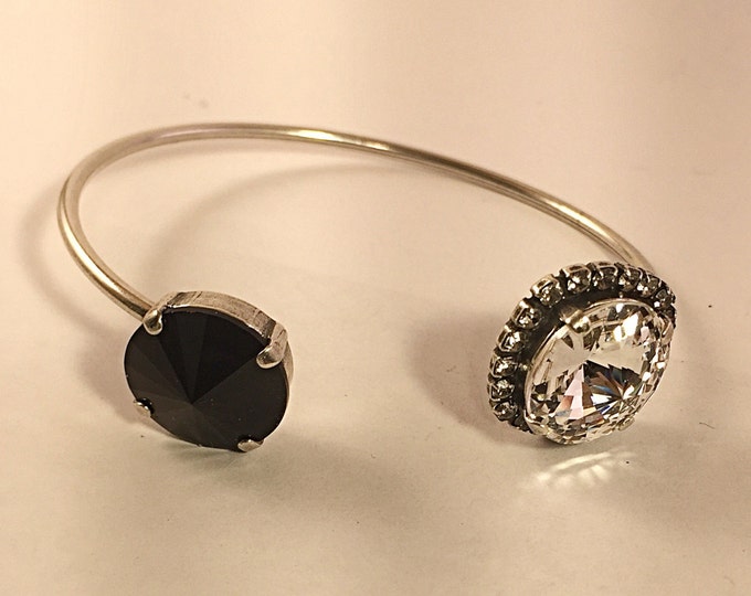 Feel glamorous and confident in this jet black and crystal rivoli bangle open cuff bracelet, perfect for stacking and layering.