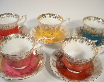 4 Royal Albert Tea Cups And Saucers, Regal Series Yellow, Red, Pink and Teal with gold filigree tea cups and saucers.