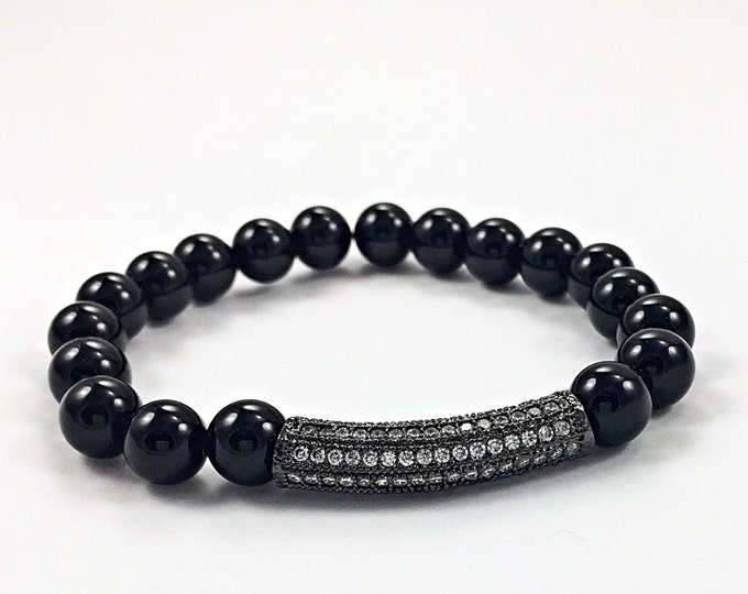 Fashionable! Black onyx 8mm beaded stretch bracelet with a polished pave crystal bar for a touch of sparkle.