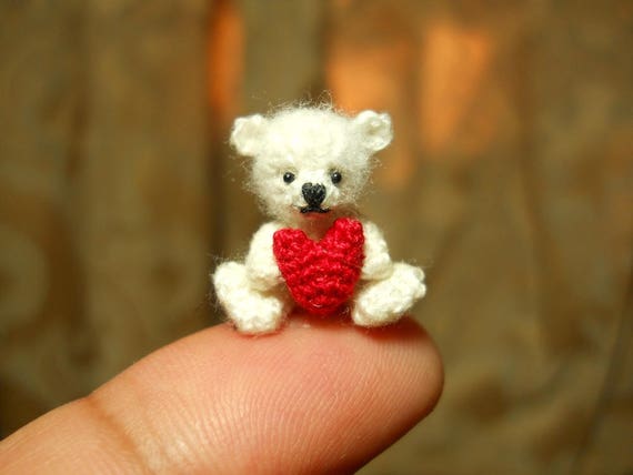 small teddy bear holding heart