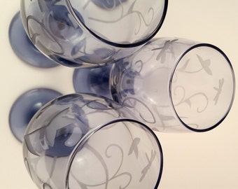 Etched wine glasses. Dragonflies and flowers on purple wine glasses.
