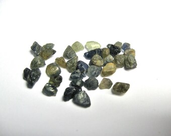 Sapphire crystals. 32 to 35 (plus or minus) pieces of natural untreated mixed colour Australian Sapphire. 20 carats plus per lot.