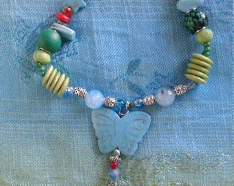 Cupid with a Butterfly Necklace, coral and turquoise