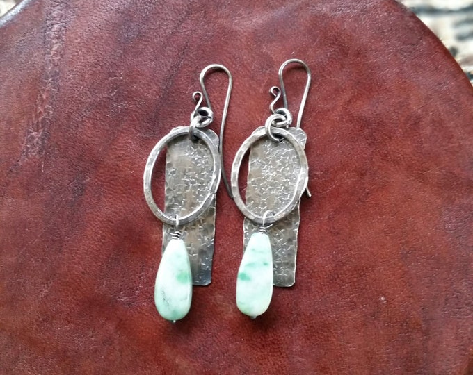 These hand forged Sterling Silver Earrings Feature Lots of Texture and an Aqua/Green Glass BeadBead