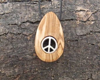 Olive wood pendant with two inlaid peace symbols