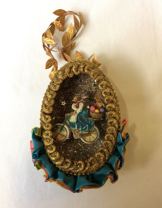 Hanging Easter egg with antique image of rabbit on bicycle