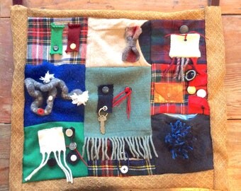 Custom made fidget blanket in rugged colors. For sensory stimulation dementia, alzheimers. Handmade to be interesting. 18" by 21"