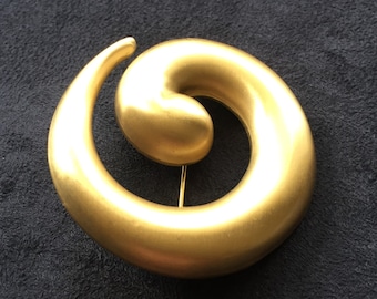 Vintage Monet satin goldtone swirl brooch. signed Monet