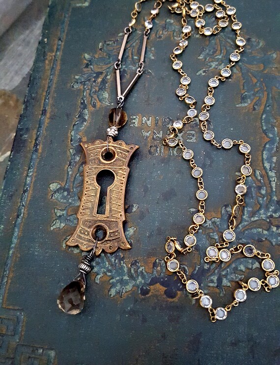 Long Crystal Chain Vintage Keyhole Necklace, Assemblage Antique Hardware Bronze, Long Pendant Necklace, Smoky Quartz Brown Stone Pendant by ViaLove steampunk buy now online Long Crystal Chain Vintage Keyhole Necklace, Assemblage Antique Hardware Bronze, Long Pendant Necklace, Smoky Quartz Brown Stone Pendant by ViaLove steampunk buy now online