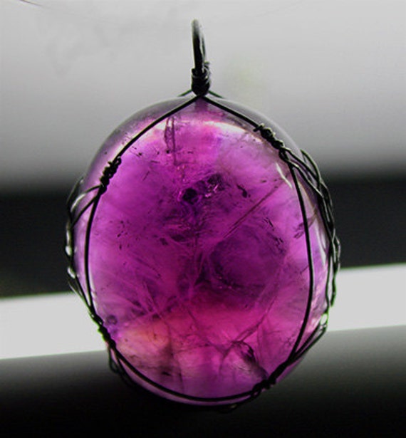 Amethyst cabochon with sterling Celtic wrap