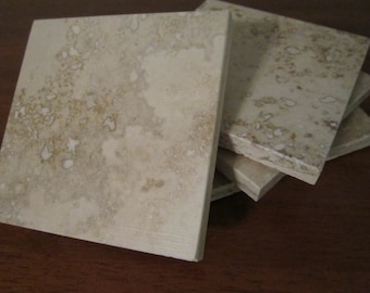 Set of 4 natural travertine coasters. Beautiful natural stone colors in darker browns and tans!