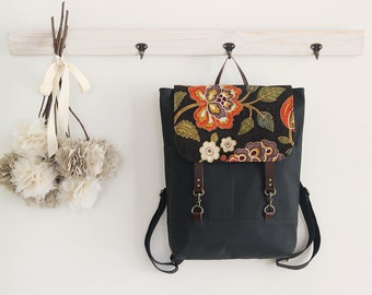 Navy canvas, Blossom flap backpack, diaper bag, diaper backpack. 2 front pockets. 7 inside pockets. Waterproof poly lining available