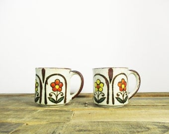 Pair of Retro Stoneware Coffee Mugs for your office kitchen or home coffee bar. 1970's stoneware mugs feature a floral boho pattern.