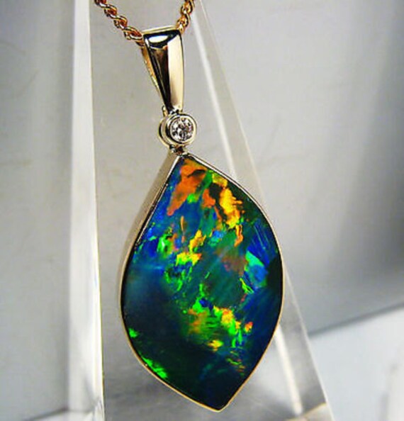 Eternal Flame 10.3cts Opal inlay on black boulder 14k solid