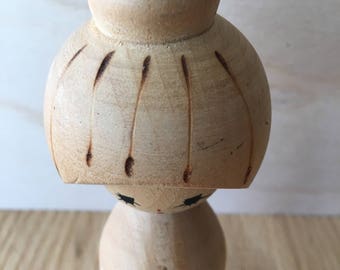 Kokeshi doll Japanese with yellow daffodils