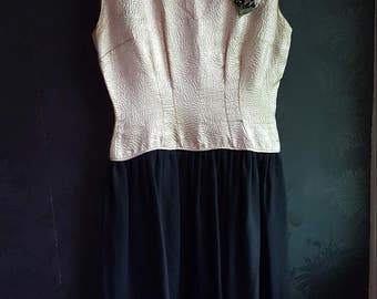 1950's cocktail dress. Handmade black & gold dress with floral corsage. Fit a Size 10. Perfect for a party dress, Goodwood revival etc.